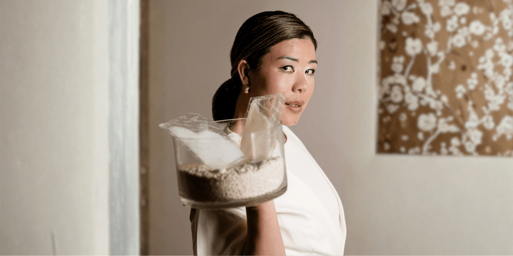 Stella Ungphongphan holding a container of rice, symbolizing her brand Rice Remedy, blending ancestral wisdom with modern wellness.