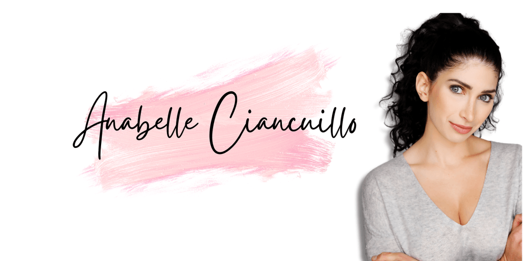 Anabelle Ciancuillo poses against a pink brushstroke background, showcasing her creative energy and passion for storytelling in Hollywood.