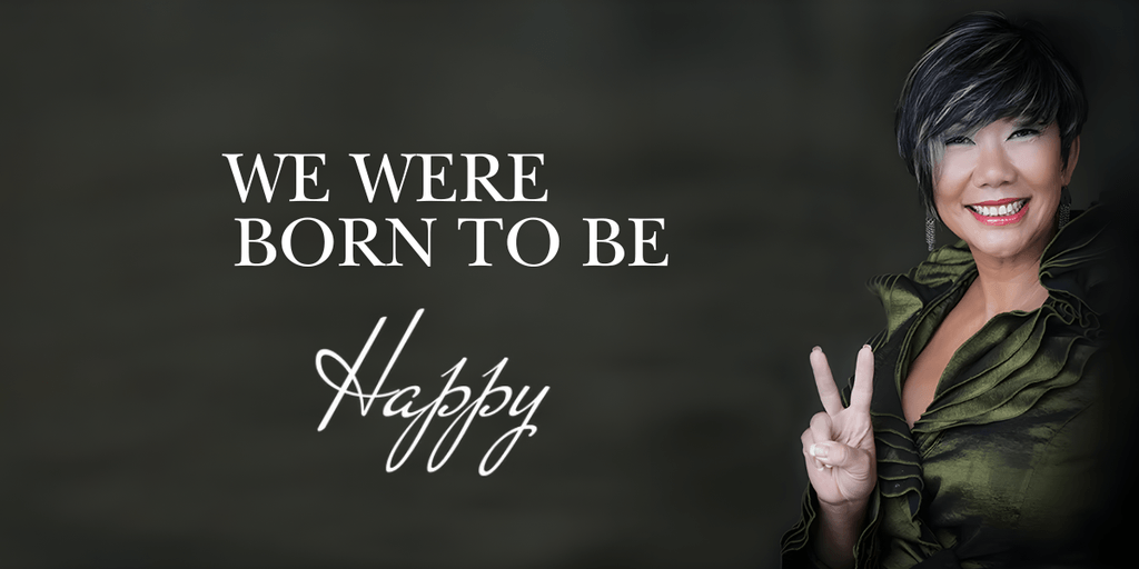 Smiling woman in green outfit flashing peace sign with text: "We Were Born to Be Happy."