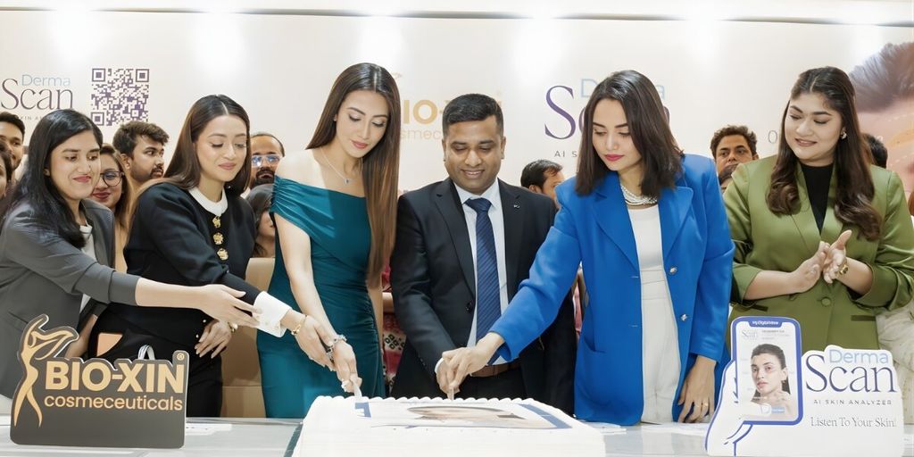 a team cutting a cake to celebrate the launch of Bio-Xin's DermaScan AI Skin Analyzer.