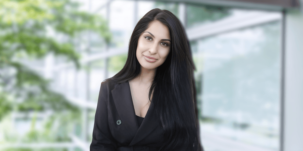 a woman with long dark hair, wearing a black blazer