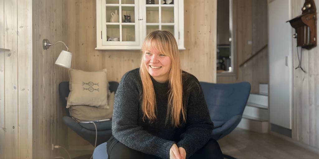 Mia Meincke Nisted, founder of Meincke Nisted, smiling warmly in a cozy setting, representing her somatic-based coaching for high-functioning women.