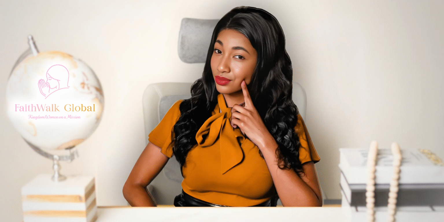 Woman in mustard blouse sitting confidently at desk with FaithWalk Global logo in background.