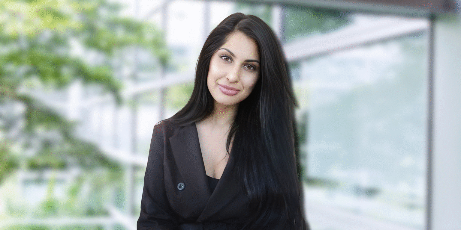 a woman with long dark hair, wearing a black blazer