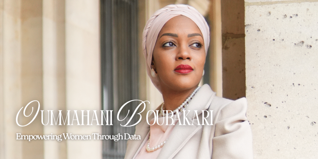 "Professional portrait of Oumahani Boubakari, an inspiring woman empowering women through data, wearing a headscarf and a beige coat, with a soft focus background."