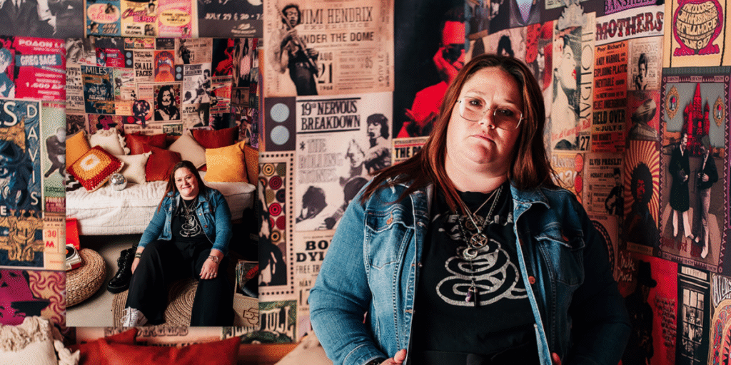 Megan Boerner, holistic coach at Out Of The Woods Coaching, posed in her music-themed room surrounded by vintage concert posters