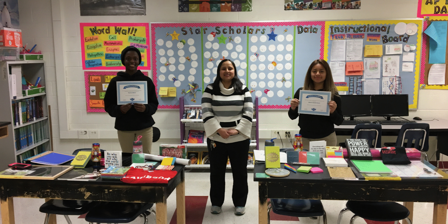 Jessica Samson, a dedicated science educator, celebrates student achievements in a classroom setting, fostering academic success in STEM