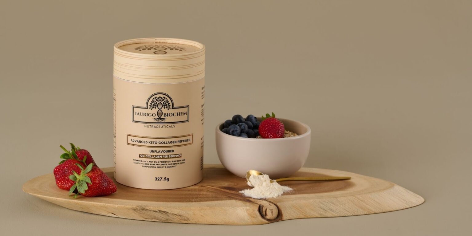 Taurigo BioChem’s Advanced Keto Collagen Peptides in eco-friendly packaging, paired with fresh strawberries, blueberries, and a spoon of powder.