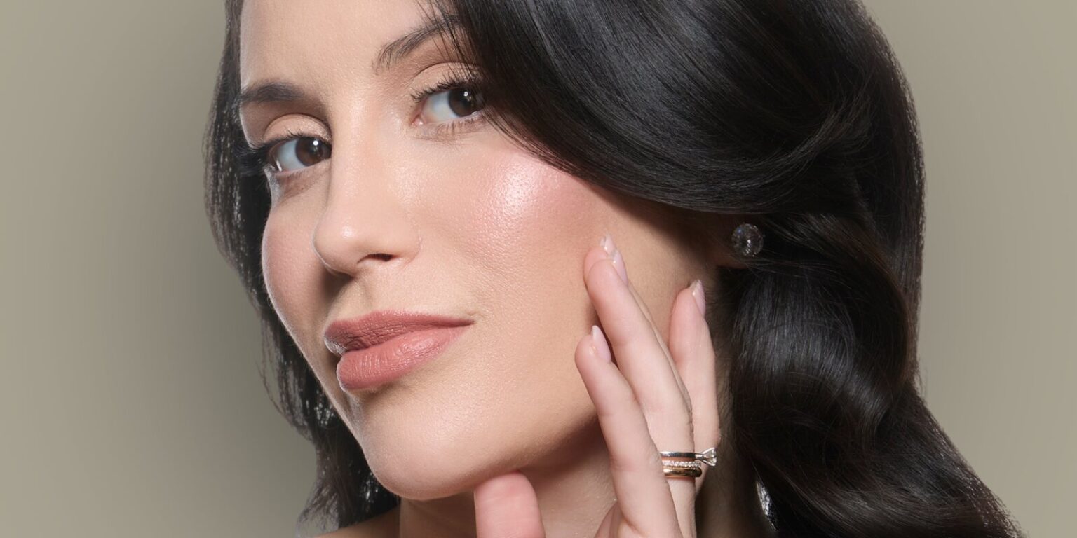 A close-up portrait of Dr. Tainah Almeida, showcasing her natural beauty, emphasizing subtle elegance and skin vitality.