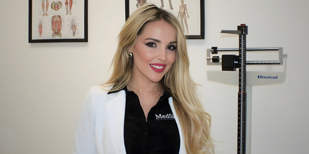 Reyna Enriquez, founder of MedSkin Laser & Rejuvenation Clinic, smiling in the clinic’s consultation room.
