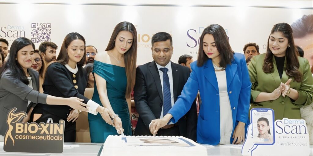 a team cutting a cake to celebrate the launch of Bio-Xin's DermaScan AI Skin Analyzer.