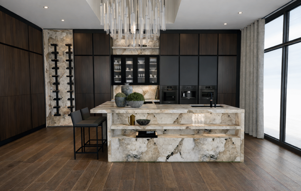 Luxury modern kitchen with marble island, dark wood cabinetry, and floor-to-ceiling windows overlooking the sea.
