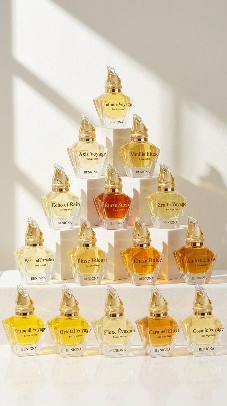 A pyramid of colorful perfume bottles displayed on a white surface, showcasing the Benigna Parfums Adventure Collection.