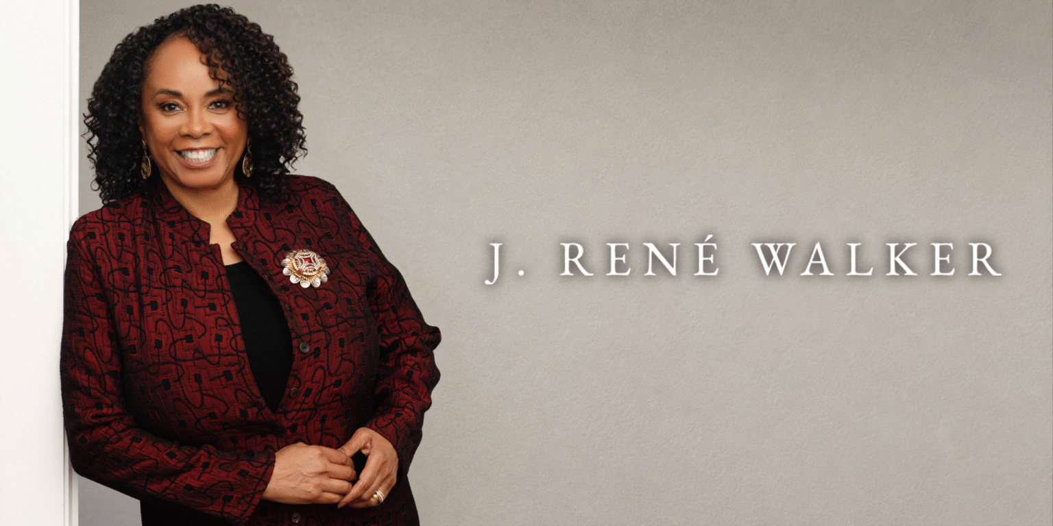 Discovering Grace: J. René Walker’s Journey to a New Kind of Fantasy J. René Walker smiles in a burgundy jacket beside her name on a neutral background.
