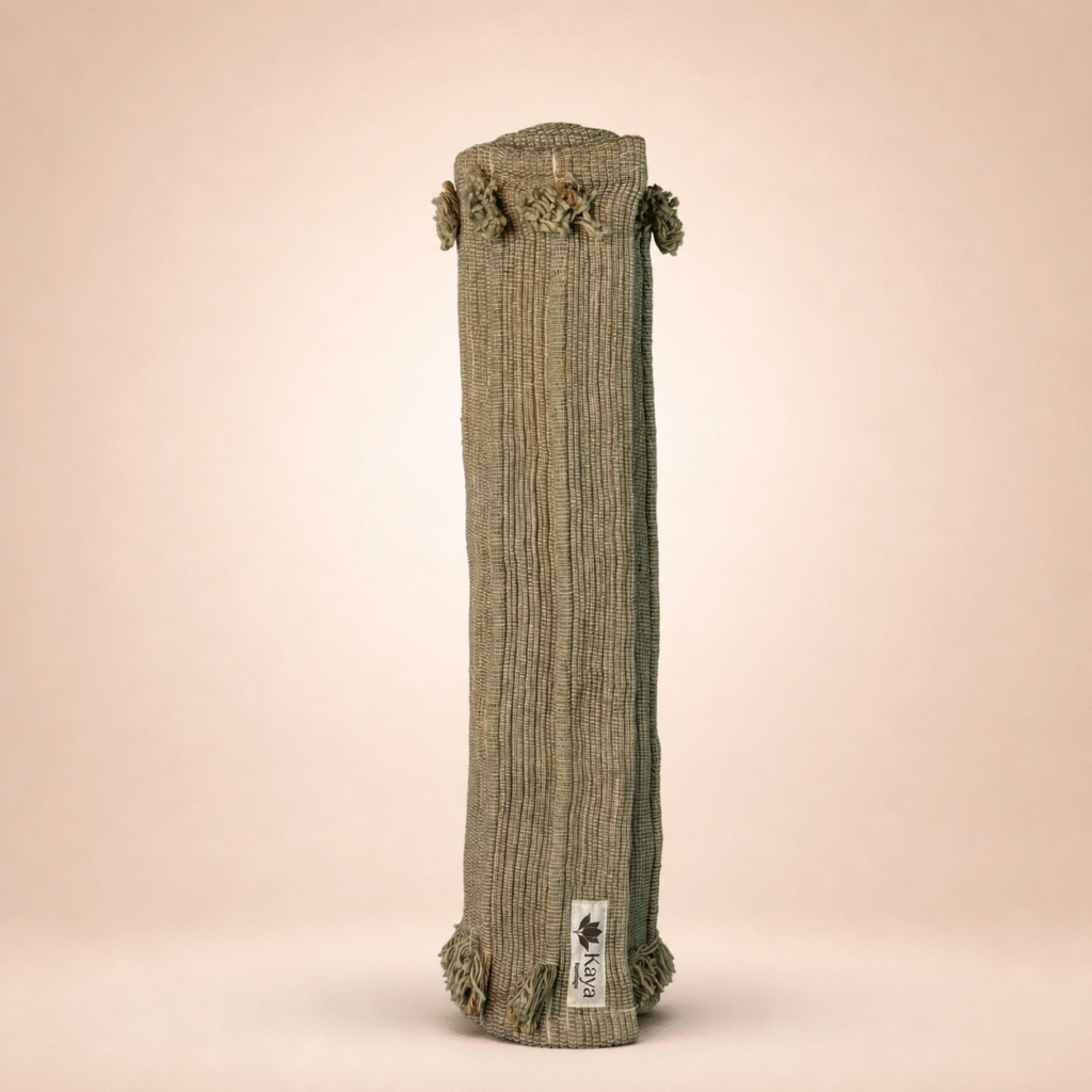 Rolled cork yoga mat with fabric carrying sleeve featuring Kaya Eco Living branding.