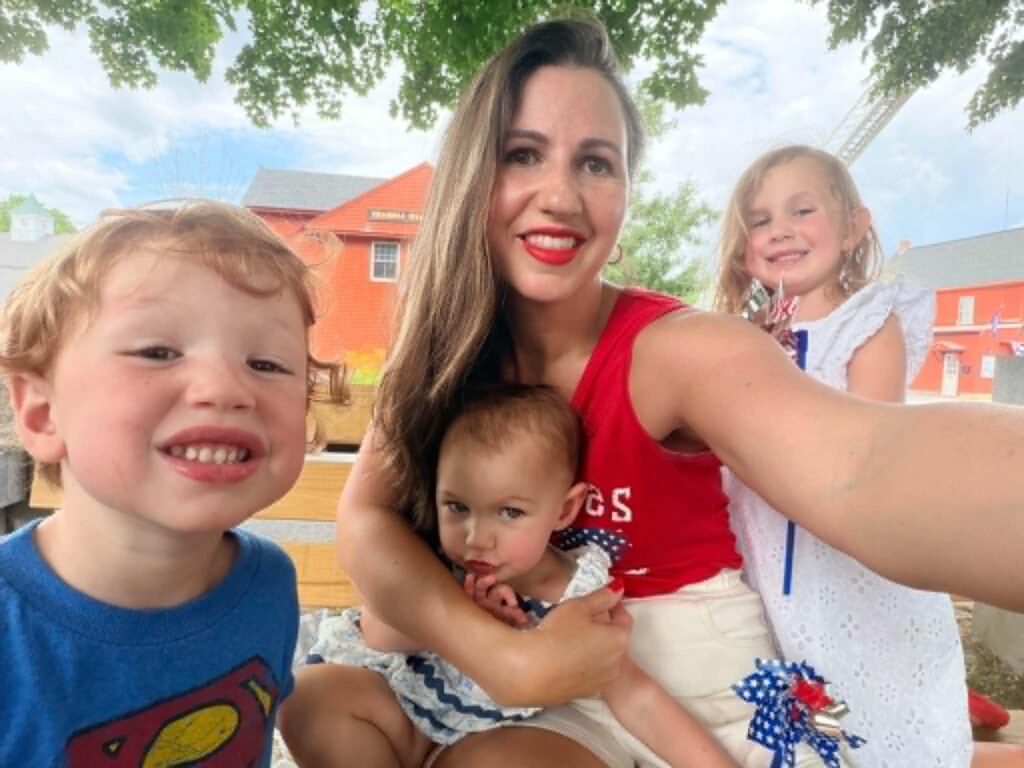 Michelle Unger smiles with her three children outdoors, reflecting family, motherhood, and personal wellness.