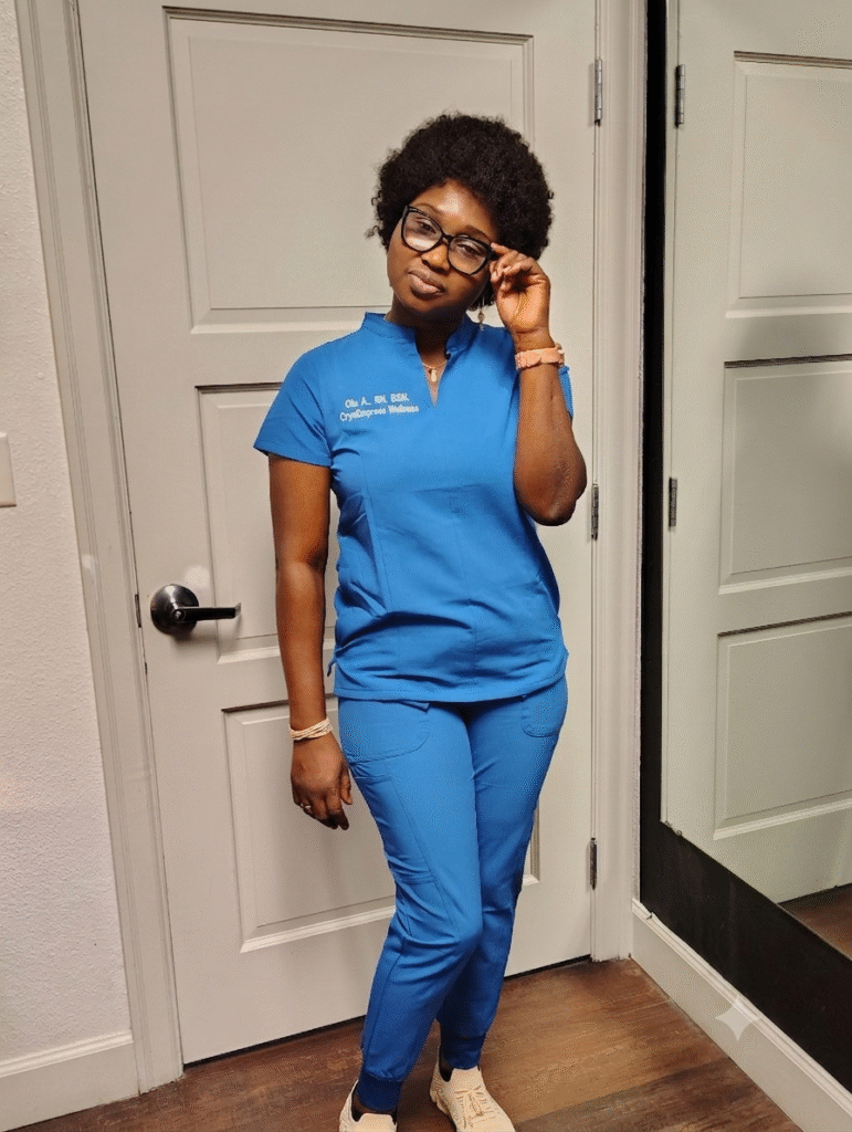 Nurse Olu wearing blue medical scrubs inside the CryoEmpress Wellness clinic.