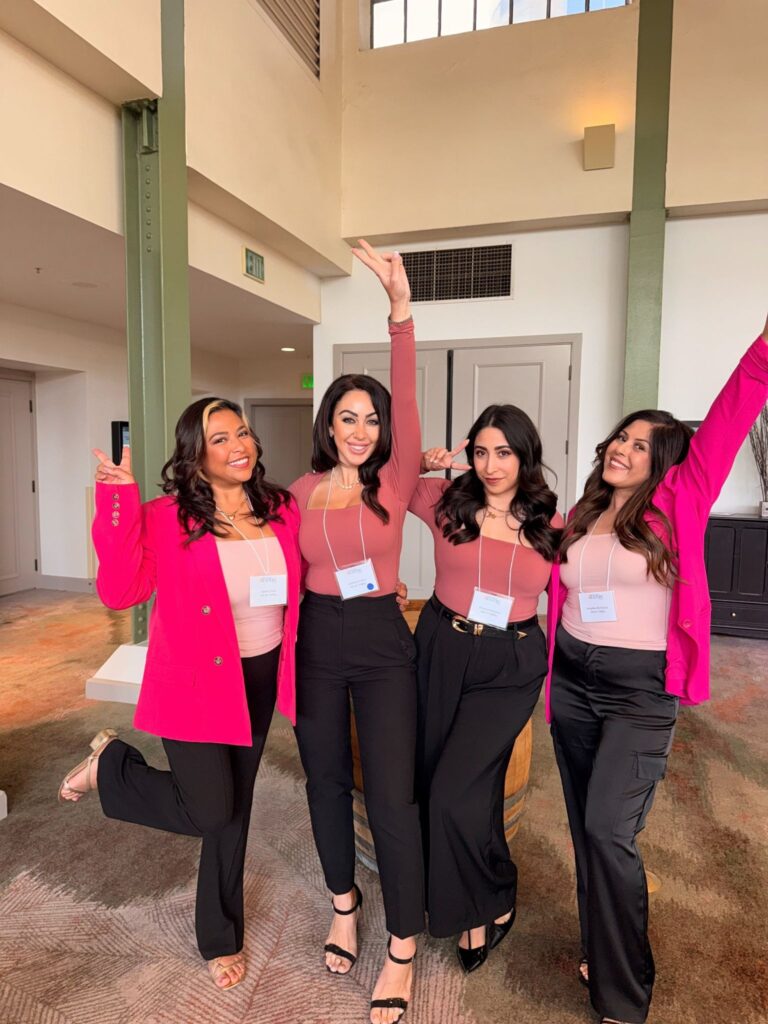 Red Carpet Real Estate Agency team members posing together at a networking event wearing name badges.